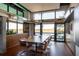 Dining room with large windows providing scenic water views and featuring a modern dining table at 905 Palm Blvd, Isle of Palms, SC 29451
