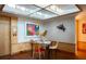 Bright dining area with sleek furniture, modern art, and a mirrored ceiling detail for added dimension at 905 Palm Blvd, Isle of Palms, SC 29451