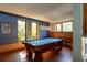Bright game room featuring a classic pool table and natural light from large windows at 905 Palm Blvd, Isle of Palms, SC 29451