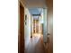 Inviting hallway with hardwood floors, blue ceiling, and natural wood trim at 905 Palm Blvd, Isle of Palms, SC 29451