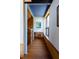 Inviting hallway with wood floors, blue accents, and a comfortable seating nook at 905 Palm Blvd, Isle of Palms, SC 29451