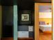 Hallway leading to the bedroom, featuring custom built-in storage and colorful accents at 905 Palm Blvd, Isle of Palms, SC 29451