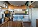 Modern kitchen with wood cabinets, stainless steel appliances, and light-filled eating area at 905 Palm Blvd, Isle of Palms, SC 29451