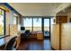 Bright home office space features custom cabinetry, large windows, and views of trees at 905 Palm Blvd, Isle of Palms, SC 29451