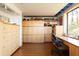 Spacious home office with custom built-in cabinetry and large windows offers ample storage and natural light at 905 Palm Blvd, Isle of Palms, SC 29451