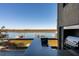 Outdoor kitchen with stainless steel grill and sleek bar area overlooking tranquil waterfront views at 905 Palm Blvd, Isle of Palms, SC 29451