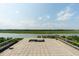 Rooftop deck overlooking a tranquil river and marshland, featuring a modern tile surface and sleek railings at 905 Palm Blvd, Isle of Palms, SC 29451