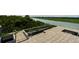 Expansive rooftop deck with a stainless steel railing that offers scenic water and lush greenery views at 905 Palm Blvd, Isle of Palms, SC 29451