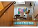 A modern staircase leads to a landing featuring a table, chairs, and a vibrant, abstract art piece at 905 Palm Blvd, Isle of Palms, SC 29451