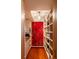 Spacious walk-in closet showcasing custom shelving, hardwood floors, and a chandelier at 905 Palm Blvd, Isle of Palms, SC 29451