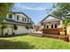 Landscaped backyard with patio, deck, and green lawn providing great space for relaxation and entertainment at 95 Gordon St, Charleston, SC 29403