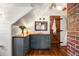Bathroom with a dark gray vanity, wood countertop, brick accent wall, and a rustic barn door at 95 Gordon St, Charleston, SC 29403