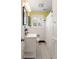 Bathroom boasts a white vanity, patterned tile floors, and a yellow accent wall at 95 Gordon St, Charleston, SC 29403