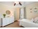This bedroom features a white twin bed, shuttered windows, a white dresser, and butterfly themed wall decor at 95 Gordon St, Charleston, SC 29403