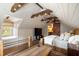 Comfortable bedroom featuring ceiling fan, exposed wood beams and access to en suite bathroom at 95 Gordon St, Charleston, SC 29403
