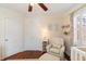 Bedroom boasts hardwood floors, a white crib, and comfortable seating area at 95 Gordon St, Charleston, SC 29403