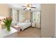 Charming bedroom featuring a white bed frame, colorful curtains and white dresser with a vase of pink tulips at 95 Gordon St, Charleston, SC 29403