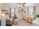 Bedroom features a white crib, floral curtains, and cozy seating area at 95 Gordon St, Charleston, SC 29403