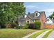 Beautiful brick home with dormer windows, mature trees, and a well-maintained lawn at 95 Gordon St, Charleston, SC 29403