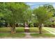 Charming brick home with a walkway, lush landscaping, and a well-maintained lawn at 95 Gordon St, Charleston, SC 29403