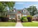 Charming brick home with dormer windows, lush landscaping, and a welcoming front porch at 95 Gordon St, Charleston, SC 29403
