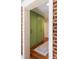 Hallway features green storage cabinets, hardwood floors, and a brick accent wall at 95 Gordon St, Charleston, SC 29403