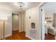Hallway features hardwood floors, stylish chandelier, and neutral walls with white trim at 95 Gordon St, Charleston, SC 29403