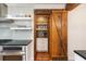 Kitchen view showcasing stainless appliances, tile backsplash, and rustic wood barn door pantry at 95 Gordon St, Charleston, SC 29403