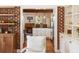 Bright kitchen showcases a decorative chandelier, island with a black countertop, and stainless steel refrigerator at 95 Gordon St, Charleston, SC 29403