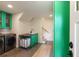 Modern laundry room with green cabinets, a utility sink, stainless steel appliances, and storage at 95 Gordon St, Charleston, SC 29403