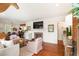 Bright living room features a fireplace, hardwood floors, and an open layout to the dining area at 95 Gordon St, Charleston, SC 29403