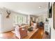 Cozy living room featuring large windows, fireplace, and an open layout to the dining area at 95 Gordon St, Charleston, SC 29403