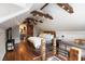 Spacious main bedroom featuring exposed beams, wood floors, a rug and a cozy bed with many pillows at 95 Gordon St, Charleston, SC 29403