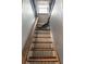 Unique staircase with wooden treads and decorative metal pattern risers leading to the upper level of the home at 95 Gordon St, Charleston, SC 29403
