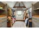 Spacious walk-in closet features custom storage, wood floors and accent beam with natural light from the window at 95 Gordon St, Charleston, SC 29403