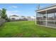 Spacious backyard with screened-in patio and wood fence surrounding the yard at 9711 Tackle St, Ladson, SC 29456