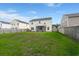 Expansive backyard with green lawn, wood fence, and screened-in porch at 9711 Tackle St, Ladson, SC 29456