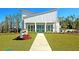 Beautiful, modern clubhouse with large windows surrounded by well-manicured lawn at 9711 Tackle St, Ladson, SC 29456