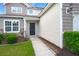 Inviting front entrance with covered porch, manicured bushes, and concrete walkway at 9711 Tackle St, Ladson, SC 29456