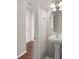 Stylish half bath features pedestal sink, modern lighting, and elegant mirror at 9711 Tackle St, Ladson, SC 29456