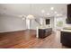 Open concept kitchen features hardwood floors and breakfast bar at 9711 Tackle St, Ladson, SC 29456