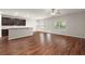 Open floorplan featuring hardwood floors, breakfast bar, and sliding glass door to backyard at 9711 Tackle St, Ladson, SC 29456