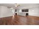 Open-concept living space featuring hardwood flooring and an adjacent kitchen with a breakfast bar at 9711 Tackle St, Ladson, SC 29456