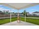 Screened-in back porch with wooden rocking chair overlooking backyard at 9711 Tackle St, Ladson, SC 29456
