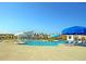 Community pool area featuring lounge chairs and vibrant blue umbrellas at 9711 Tackle St, Ladson, SC 29456
