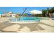 Community pool area featuring a splash pad and umbrella-covered seating at 9711 Tackle St, Ladson, SC 29456