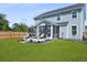 Large backyard with a screened patio, comfortable seating, and lush green lawn, ideal for outdoor entertaining at 1004 Saltwater Cir, Johns Island, SC 29455