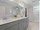 Bright primary bathroom with double vanity, stylish fixtures, and walk-in shower at 1004 Saltwater Cir, Johns Island, SC 29455