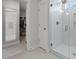 Modern bathroom featuring a tiled shower, glass door and a view into the walk-in closet at 1004 Saltwater Cir, Johns Island, SC 29455