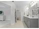 Elegant bathroom featuring double vanity with gray cabinets and a separate room for lavatory at 1004 Saltwater Cir, Johns Island, SC 29455